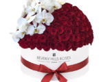 Red roses with white orchids in 'Hollywood Royal Globe'